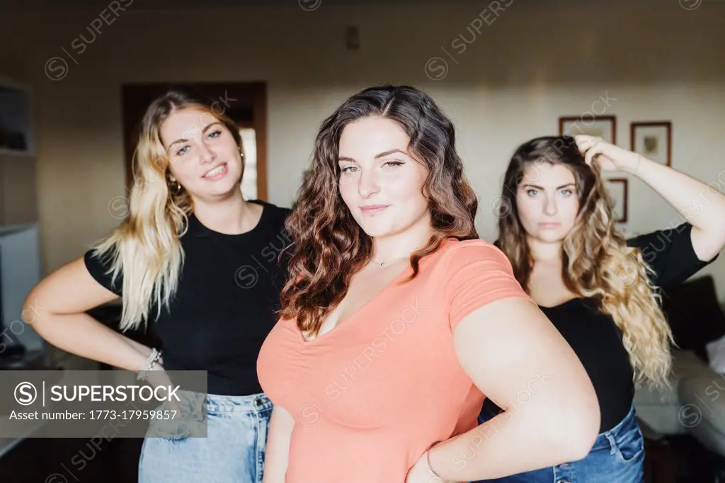 Portrait of three confident young women at home