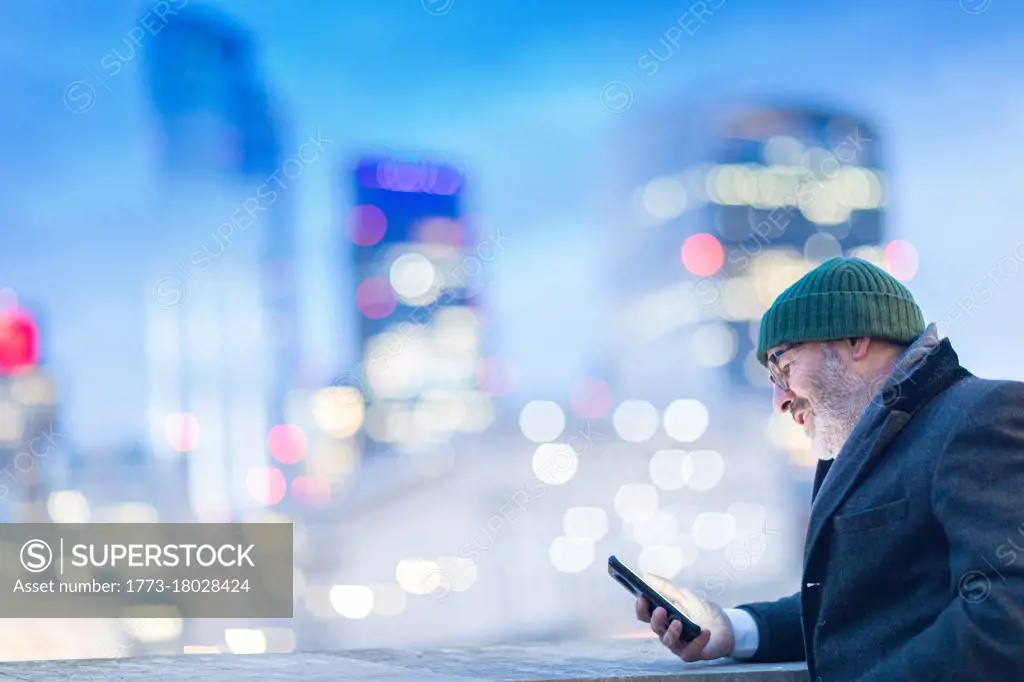 Man using phone in city, London, UK