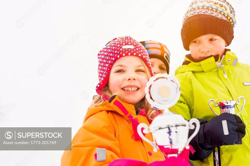 Portrait of children holding trophies