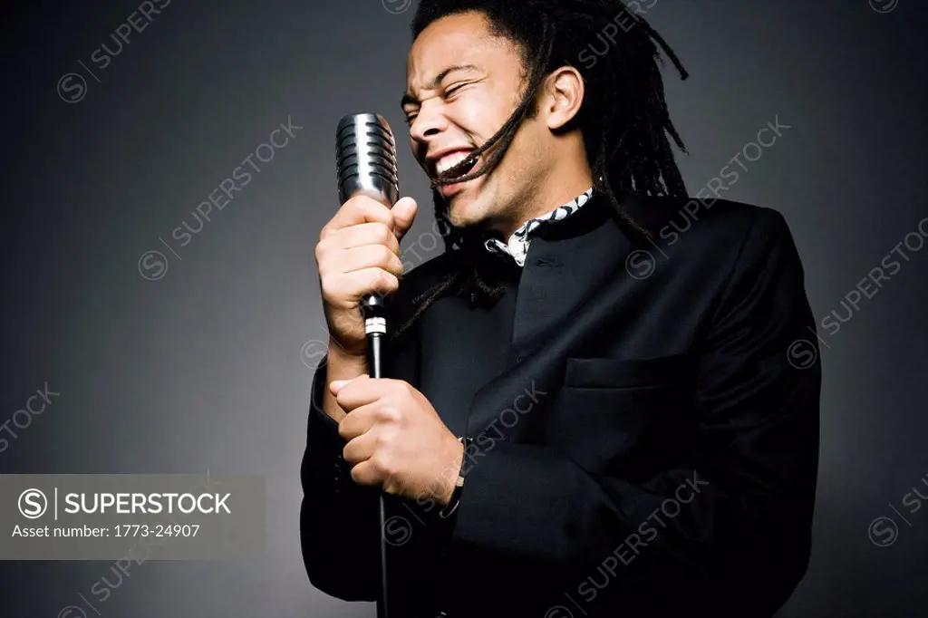 man shouting into mic side view