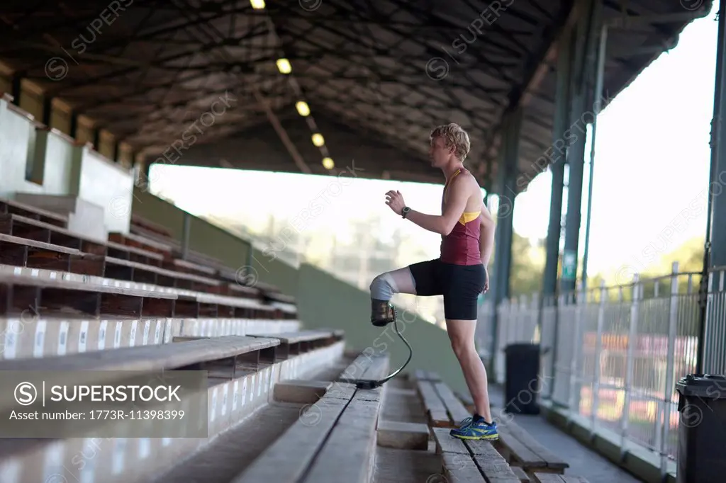 Sprinter walking with prosthetic leg on