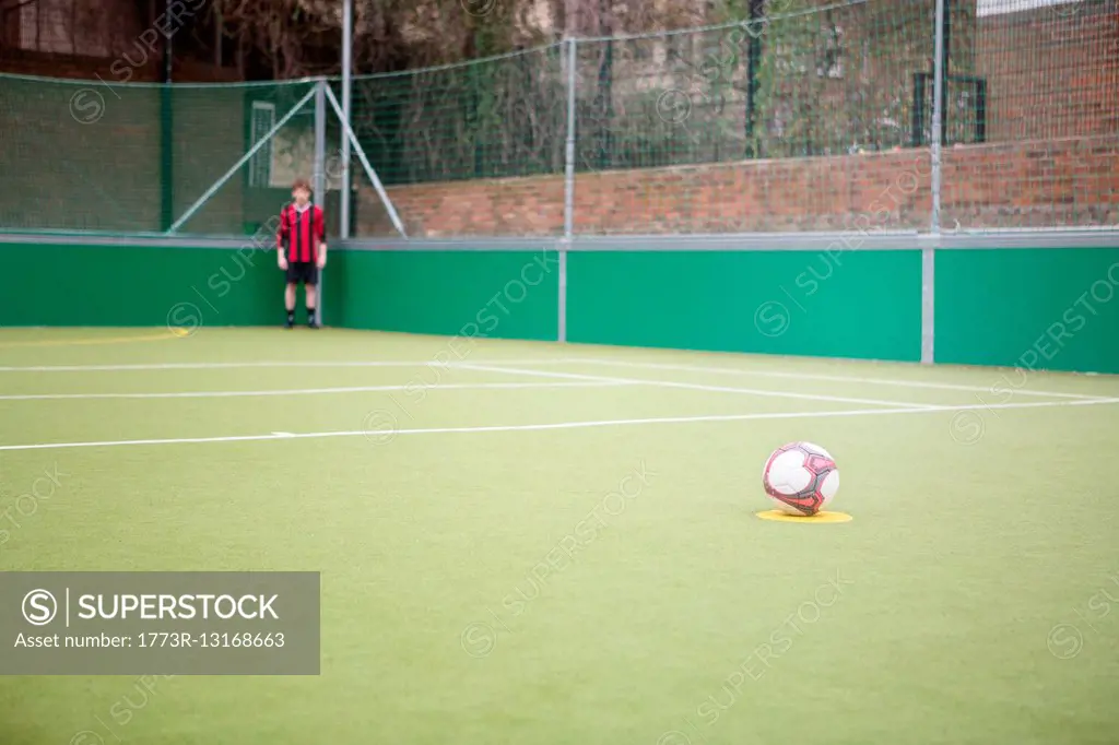 Young man on urban football pitch