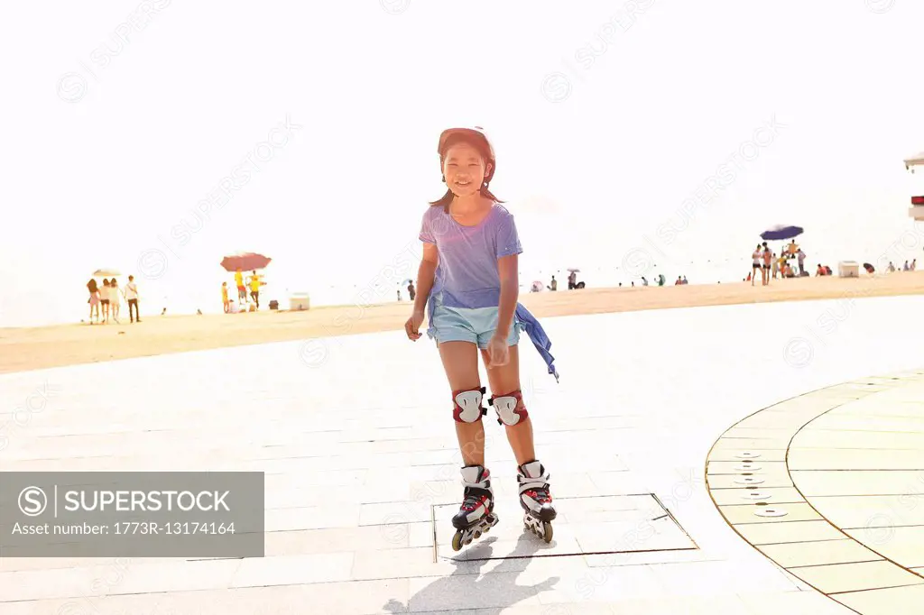 Girl rollerblading at beach, Zhuhai, Guangdong, China