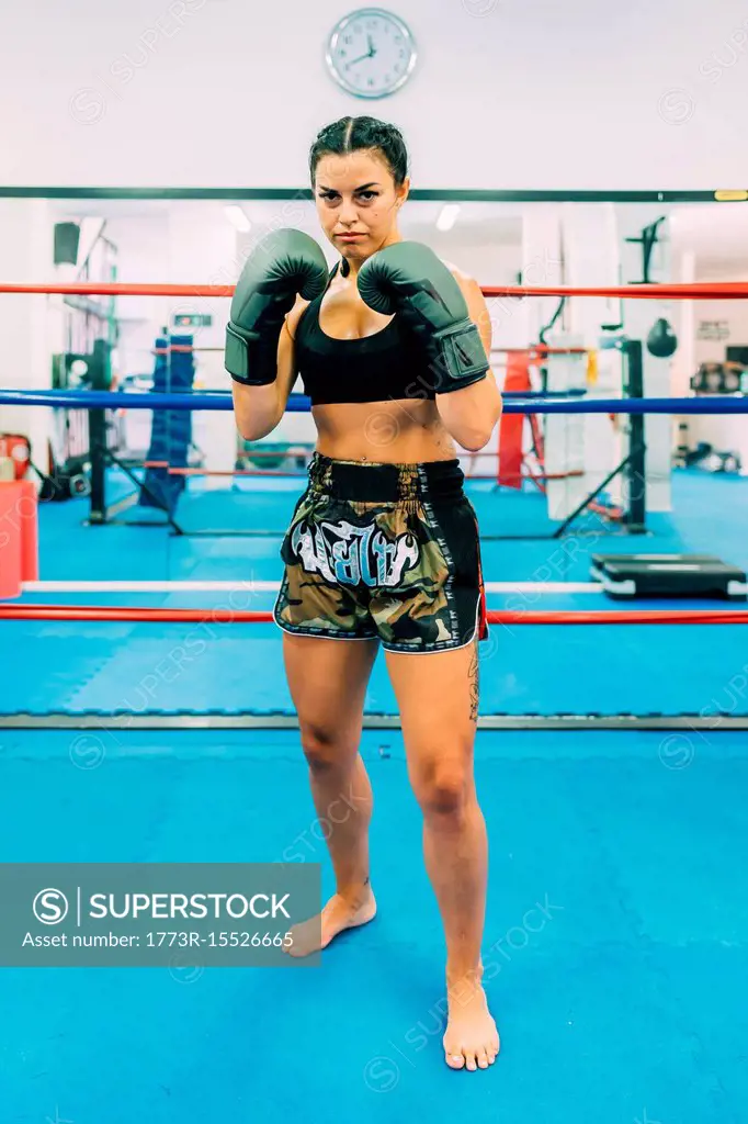 Portrait of female boxer in boxing ring