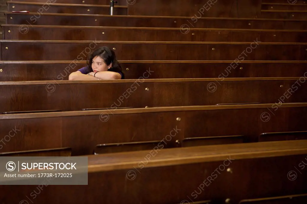 Student resting head on desk in class