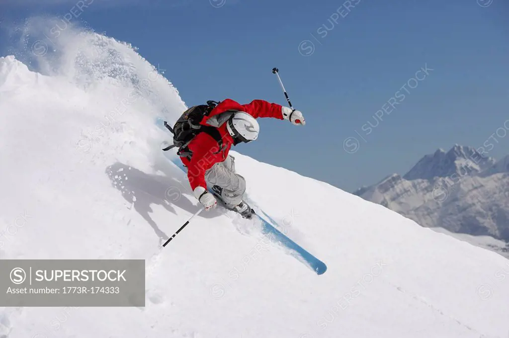 man skiing down mountain slope