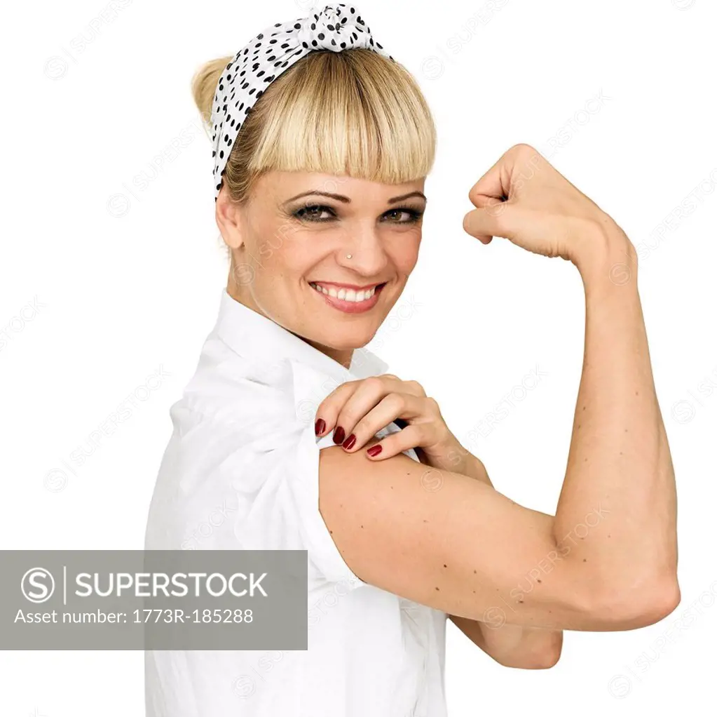 Smiling woman flexing arm muscle