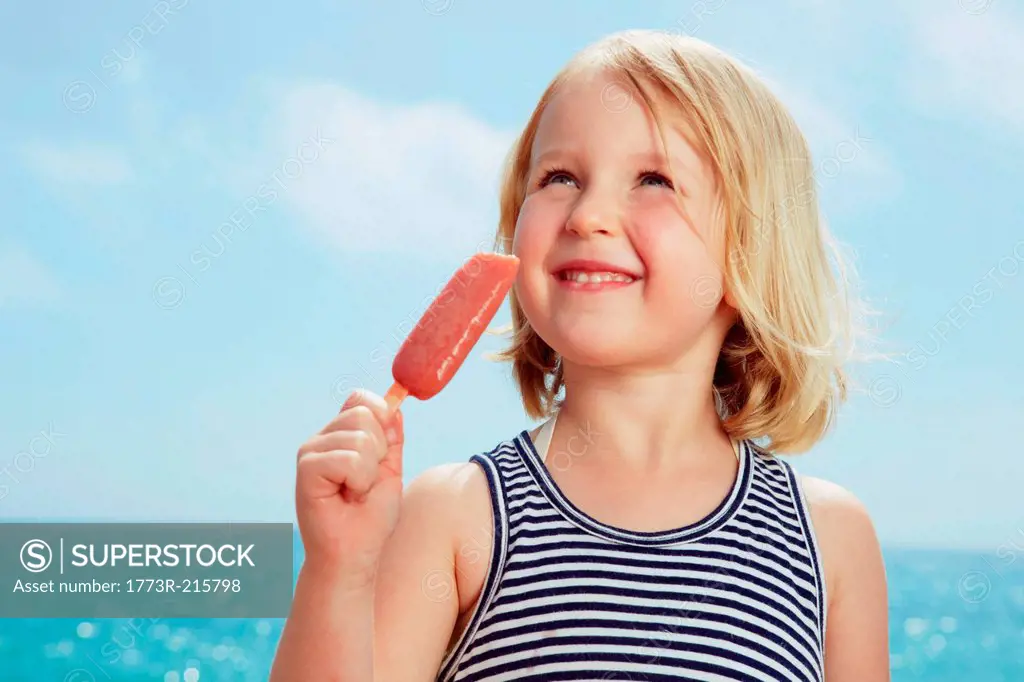 Child with ice lolly looking up