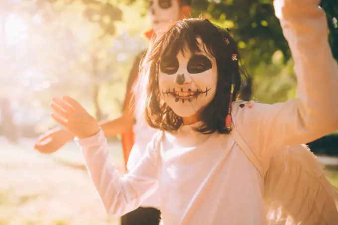 Happy girl in Halloween face paint