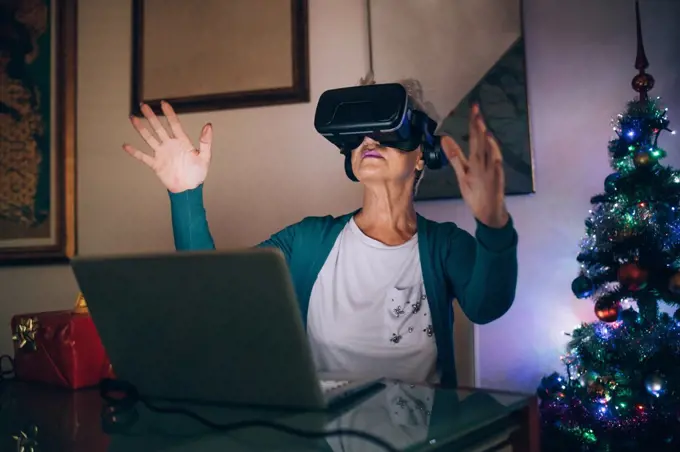 Woman using virtual reality headset at home