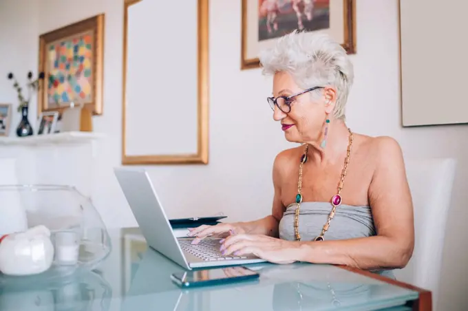 Senior woman working at home