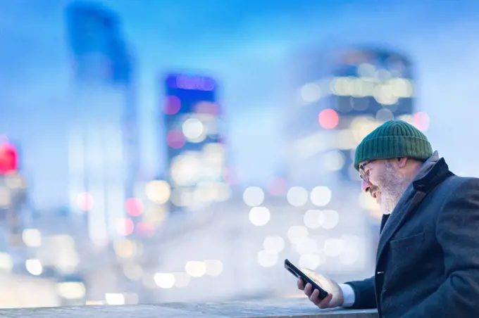 Man using phone in city, London, UK