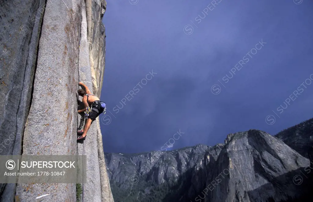 A male rock climber lead climbing a granite big wall in Yosemite National Park