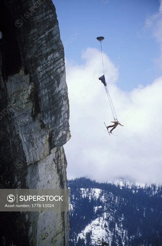 Ski-BASE jumper doing a backflip off a cliff near Lake Tahoe