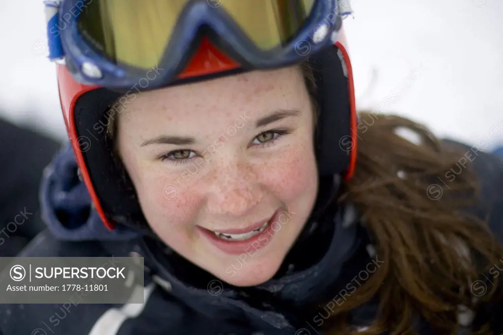 A  young woman on vacation snowboarding smiles at Sunday River ski resory in Bethel, Maine