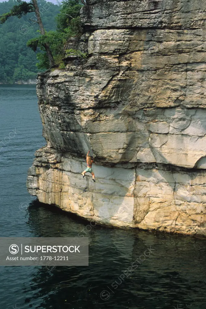 Female deep water soloing at Summersville Lake, West Virginia