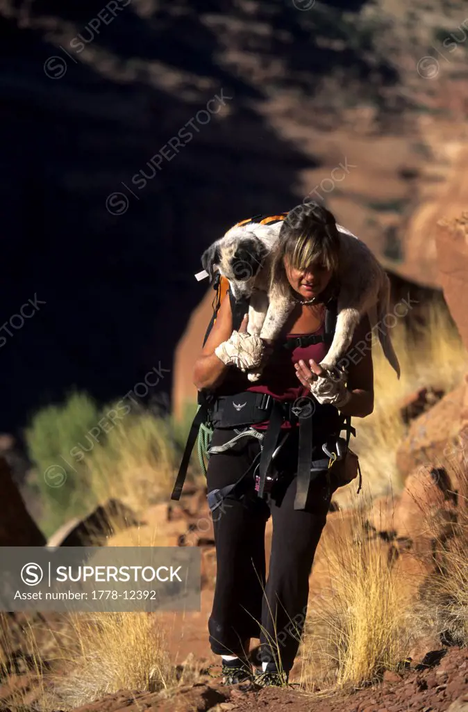 Woman hiking with her dog at Indian Creek Canyon Rims Recreation Area, Utah