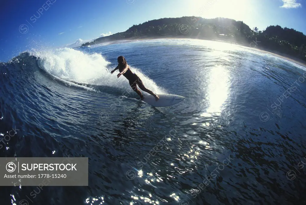 woman surfing north shore, Hawaii