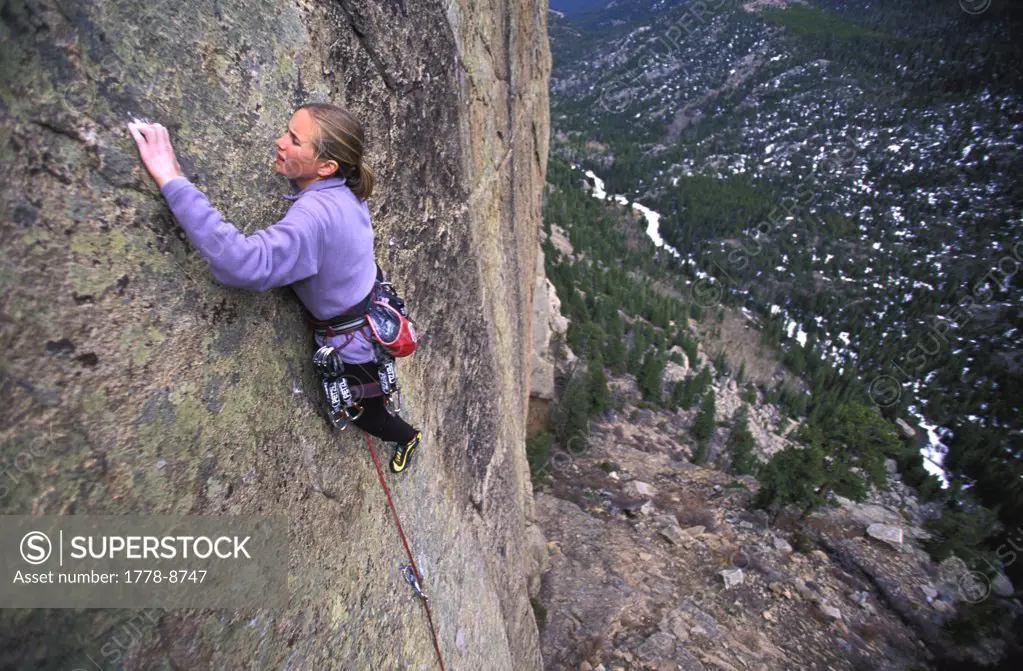 Woman rock climbing in Rocky Mountain National Park, Colorado