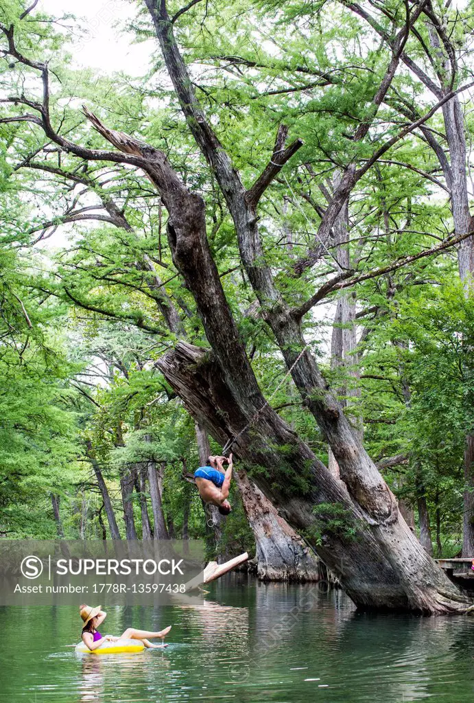 The Blue Hole in Wimberley, Texas is a popular destination for tourists and locals on hot summer days. The clear, cool water flows through cypress tre...