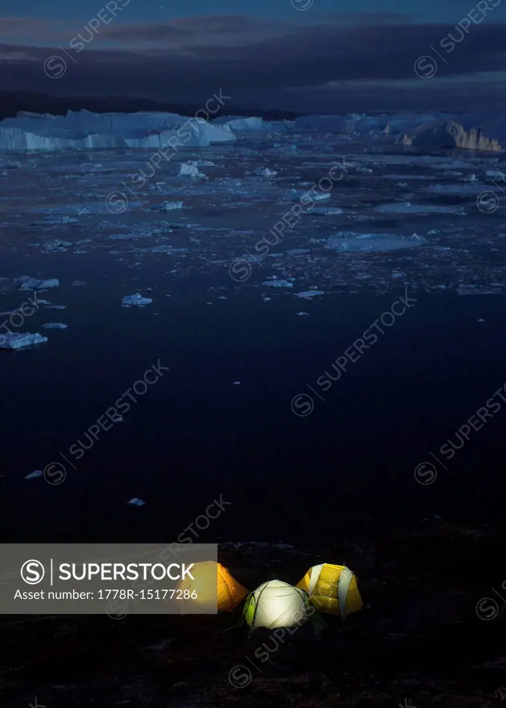 Icy but beautiful night time camping along the shores of the Ilulissat Icefjord in Greenland. This area is home to some of the world's largest iceberg...