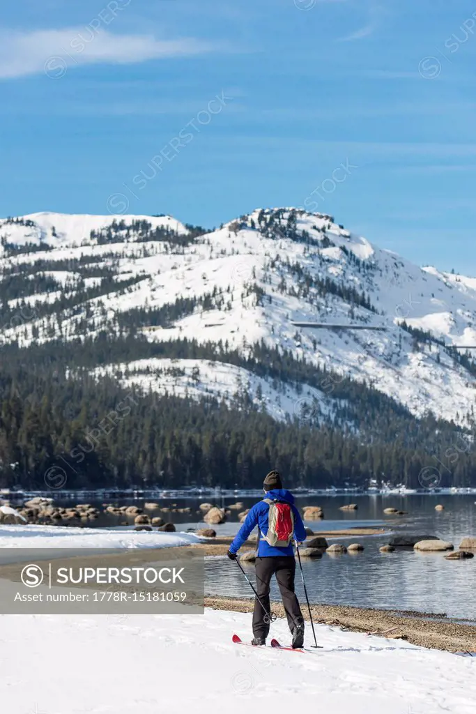 Woman skiing along shores of Donner Lake