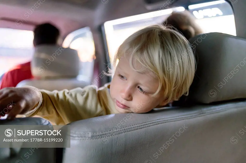 Photograph of young blonde boy inside car, Bedugul, Bali, Indonesia