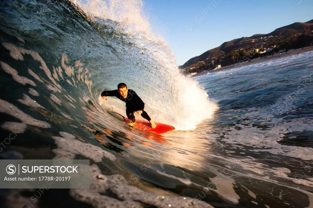 A male surfer gets barreled at Zuma beach in Malibu, California.