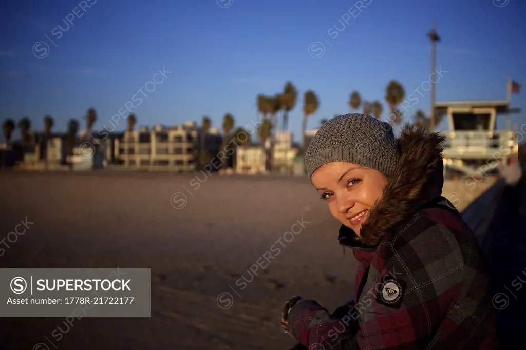 Smiling woman in knit hat looking at camera at Venice Beach, Los Angeles, California, USA