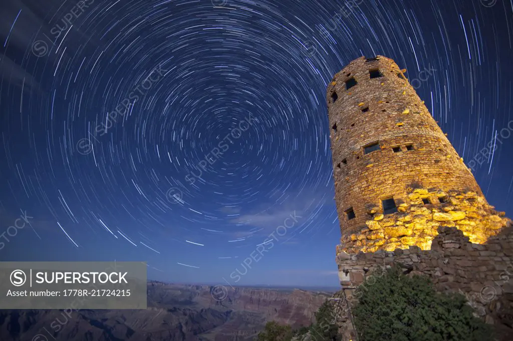 Scenic view with tower at southern rim of Grand Canyon under star trails at night, Arizona, USA