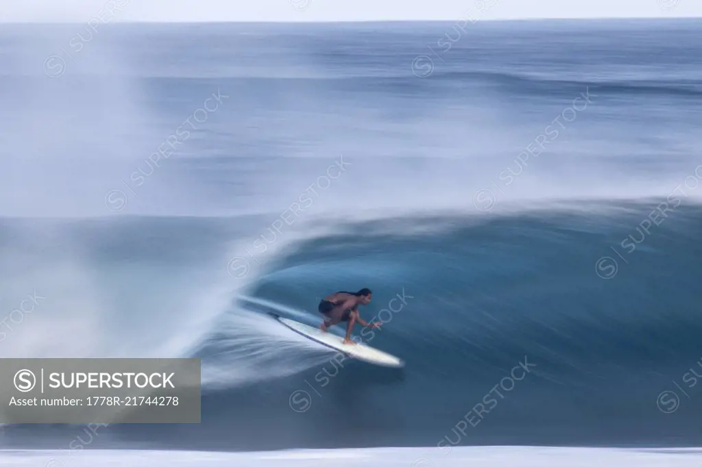 A surfer riding a big wave at the world famous Banzai Pipeline, on the North shore of Oahu, Hawaii.