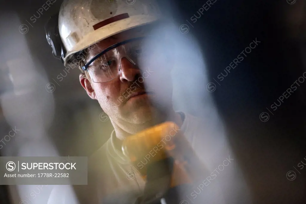 A natural gas plant technician in a hardhat.