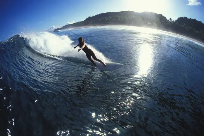 woman surfing north shore, Hawaii