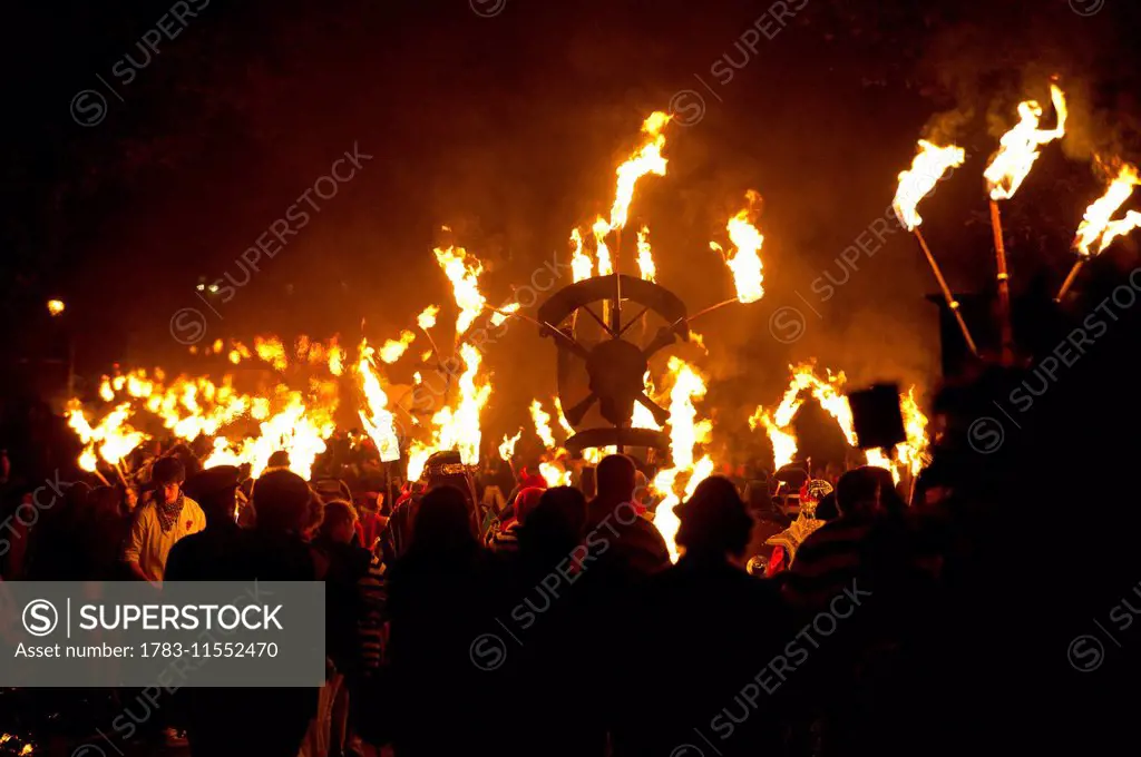 People marching along road for the East Hoathly Bonfire night; East Sussex, England