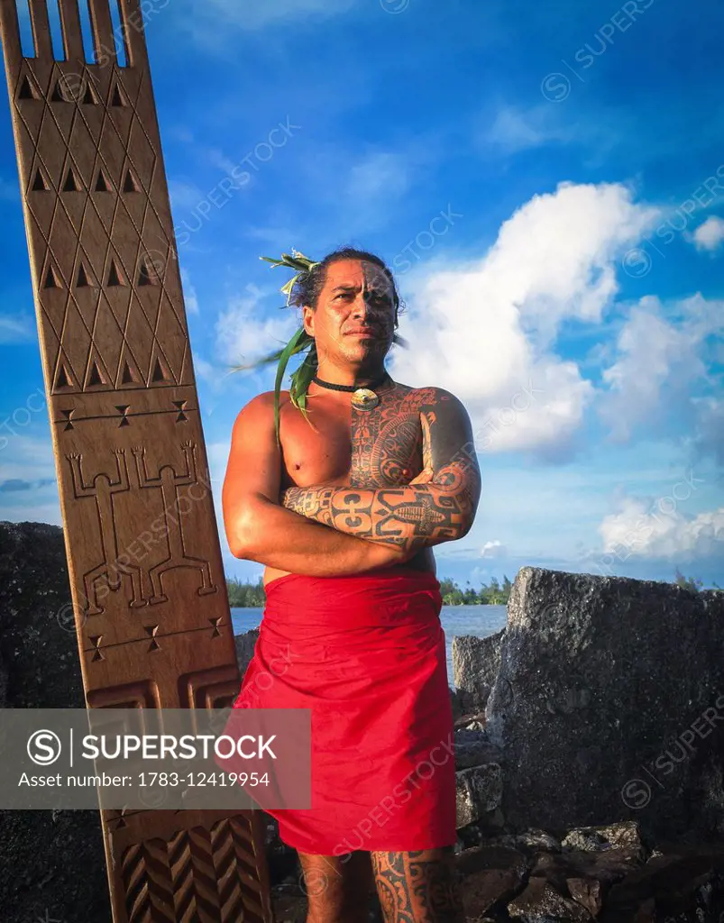 Tihoti, a tahitian Tattooist standing on sacred site; Tahiti