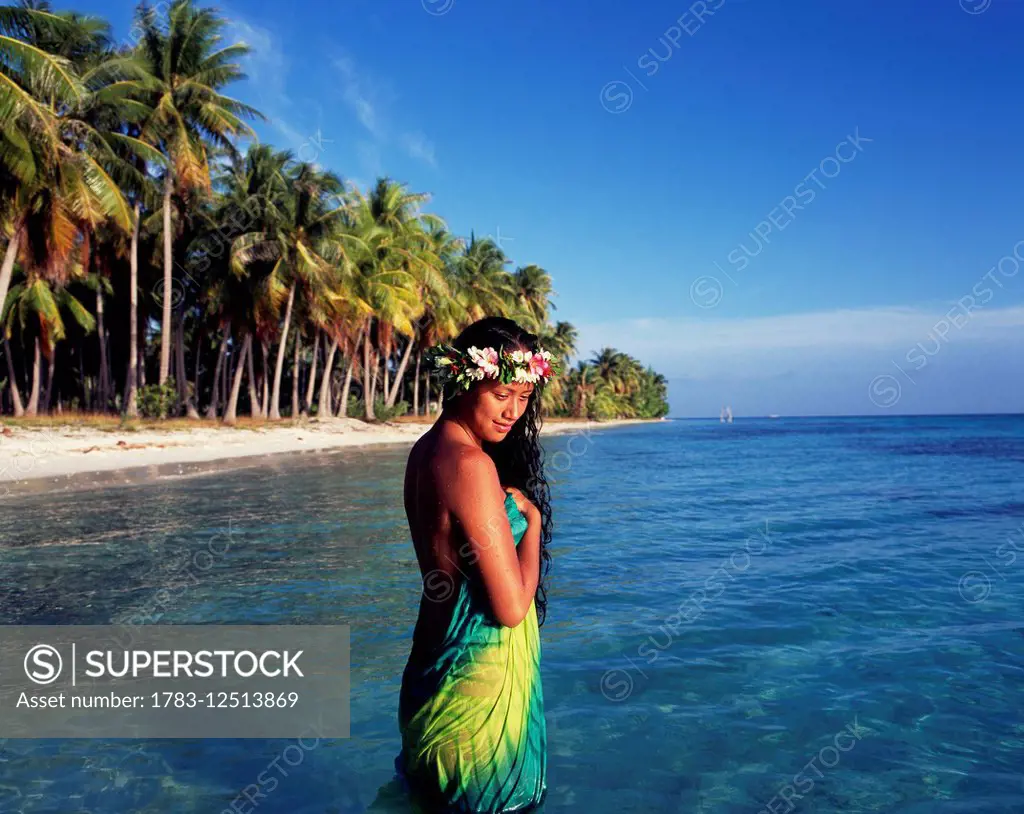 Tahitian woman bathing by the waters edge; Tahiti