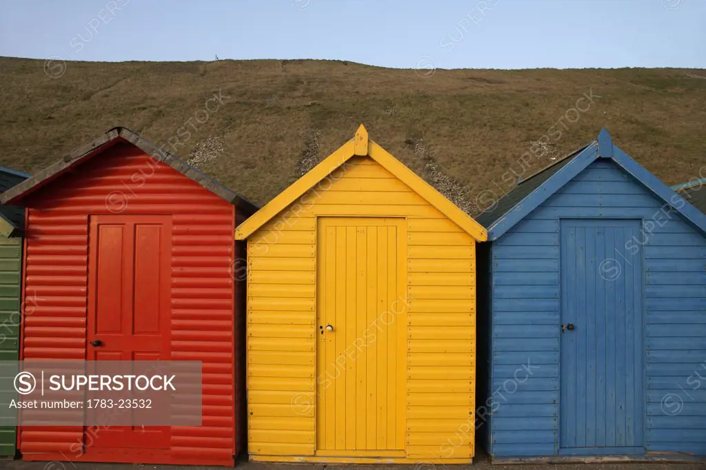 Row of colorful beach huts, Whitby, North Yorkshire, England.