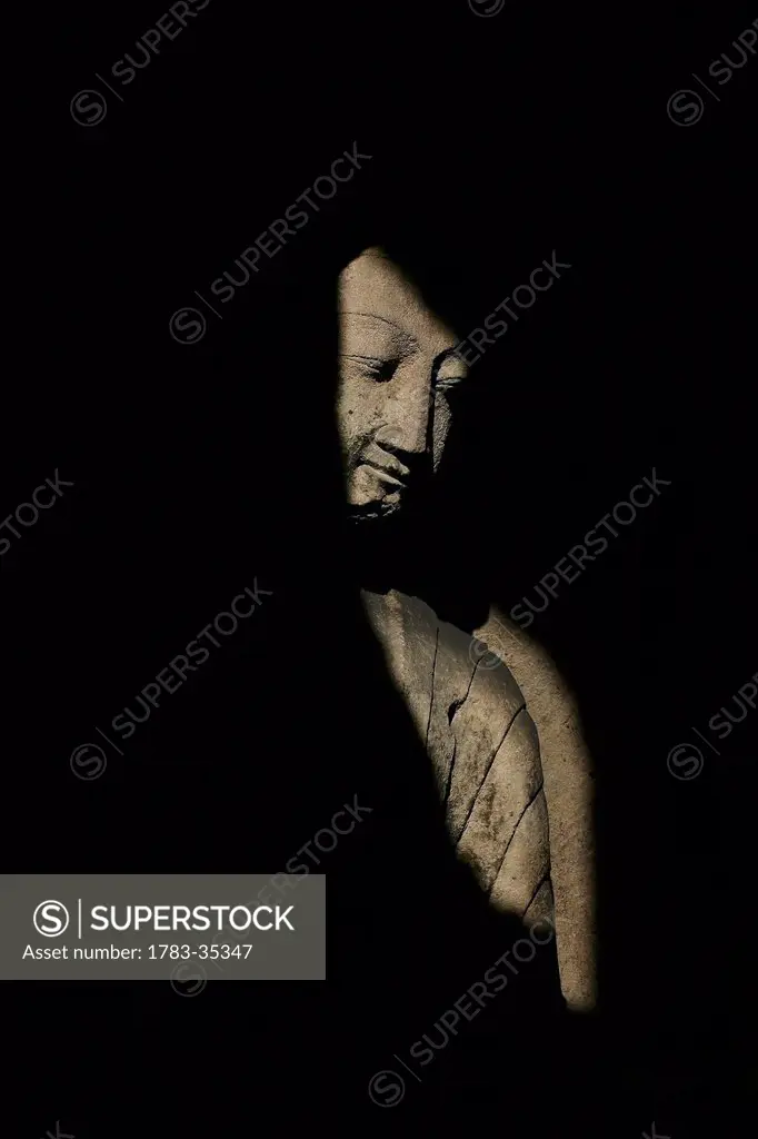 Buddha Statue In Shadows, Yungang Caves,Wuzhou Shan Mountains,China