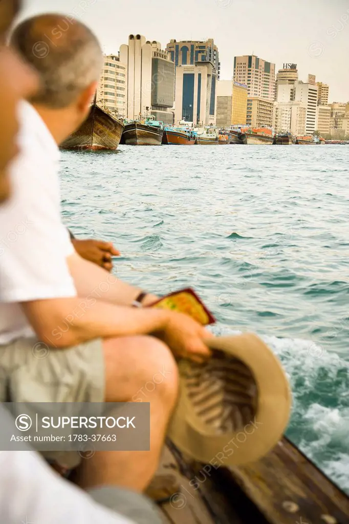 Tourists riding small ferry on Dubai Creek; Dubai, UAE