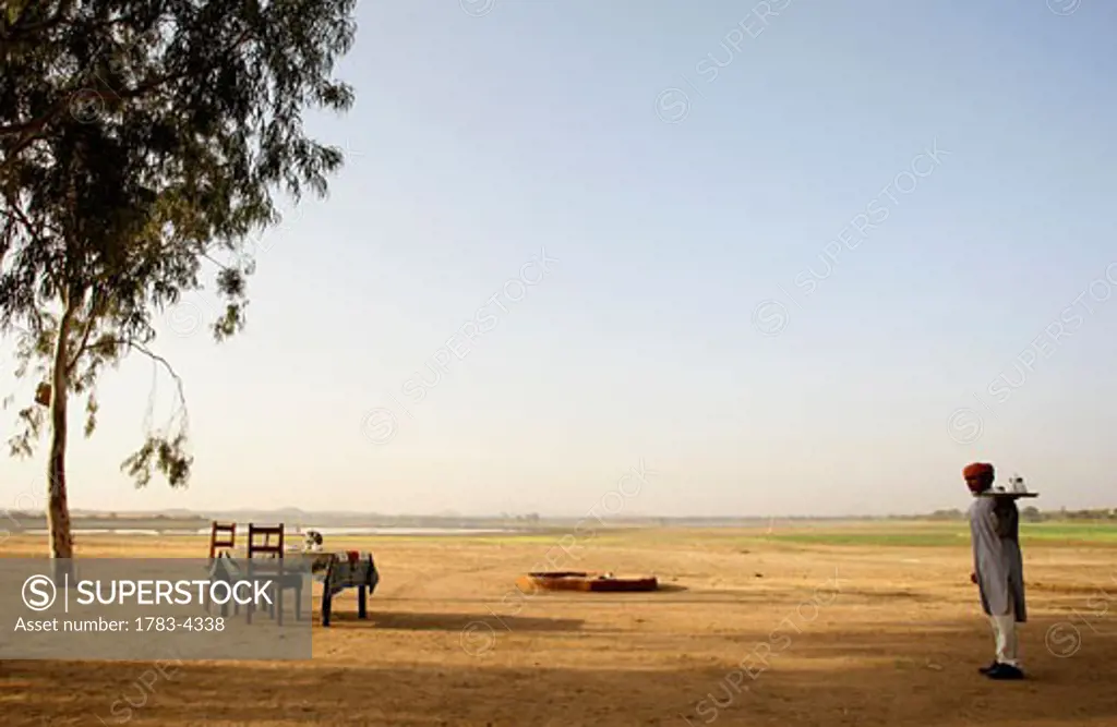 Waiter carrying tray at Deogarh Khayyam Desert Camp, Rajasthan, India