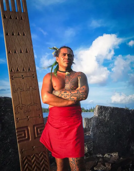 Tihoti, a tahitian Tattooist standing on sacred site; Tahiti