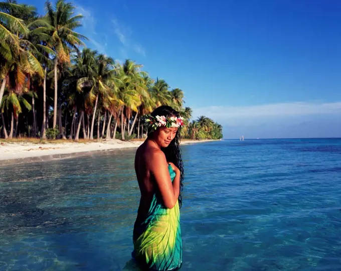 Tahitian woman bathing by the waters edge; Tahiti