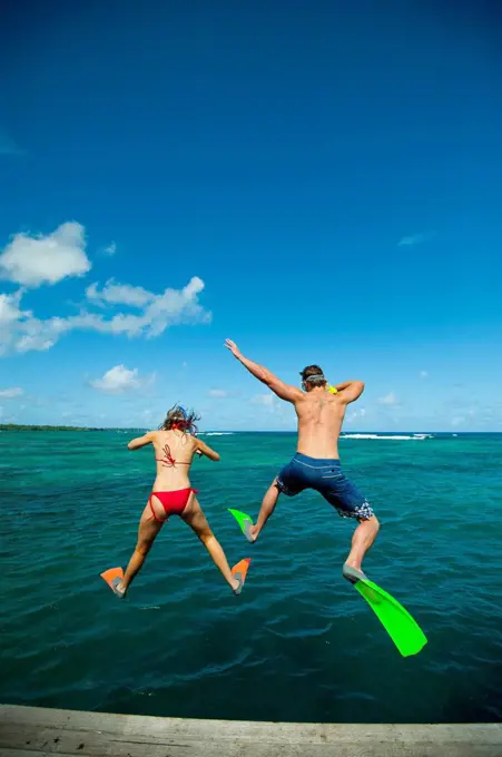 Snorkellers jumping into the waters off Uplulu Island; Upulu, Samoa