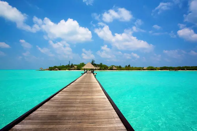 Jetty with cabana over crystal clear turquoise sea, Maldives