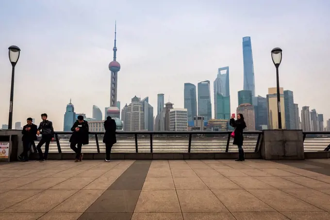 Pudong skyline with its landmark skyscrapers seen from the opposite side of the Huangpu river; Shanghai, China