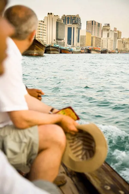 Tourists riding small ferry on Dubai Creek; Dubai, UAE