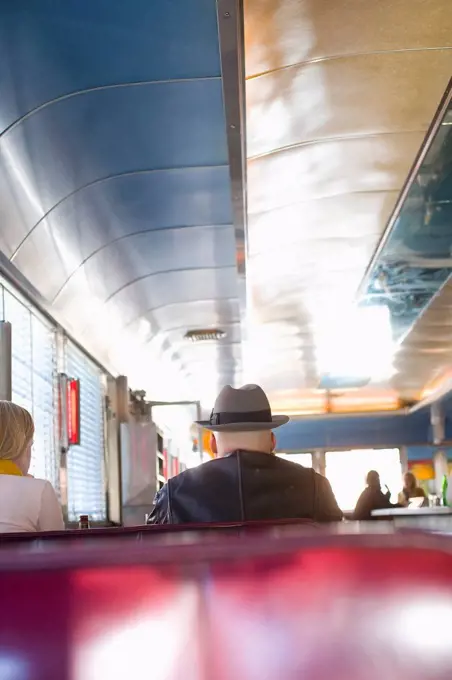 USA, New York State, New York City, Brooklyn, Men eating cheeseburgers at Relish Diner; Williamsburg