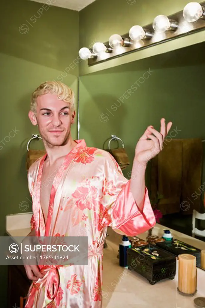 Drag queen wearing robe in bathroom