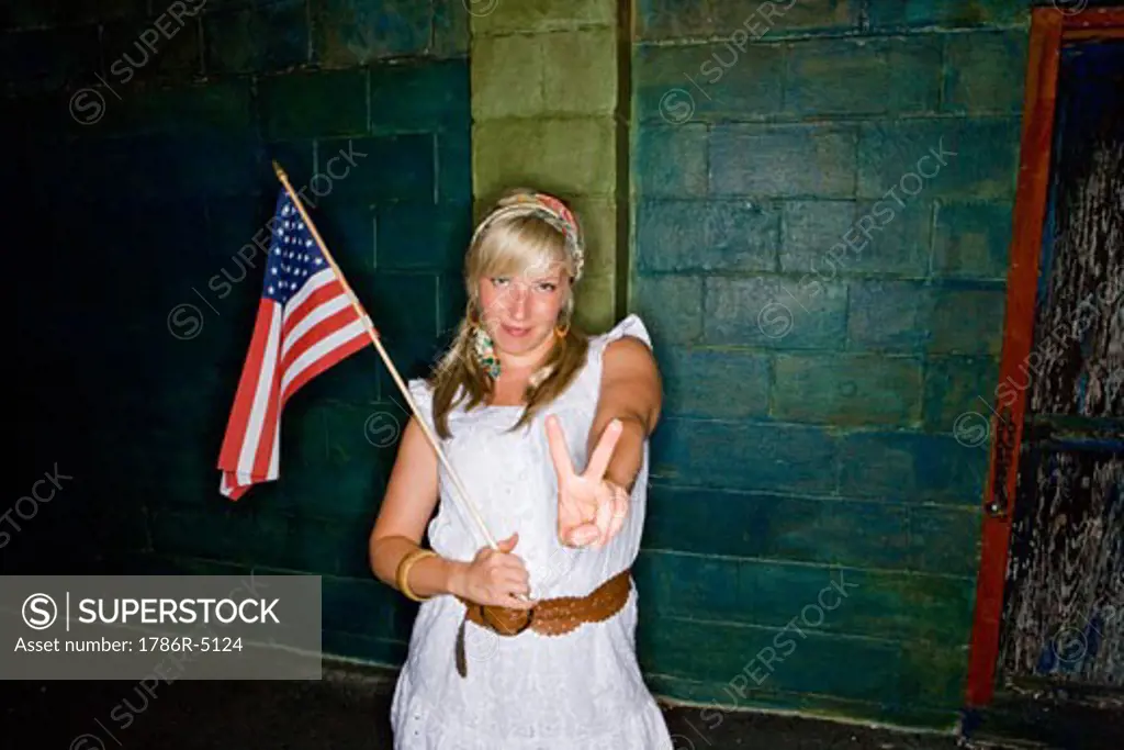 Mature woman holding a American flag and gesturing