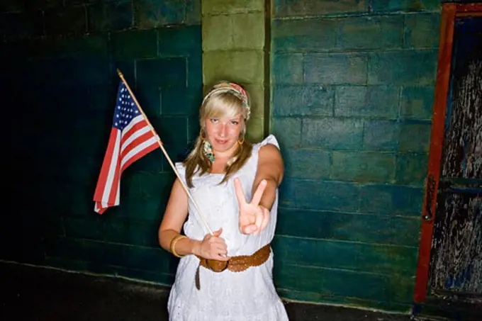 Mature woman holding a American flag and gesturing